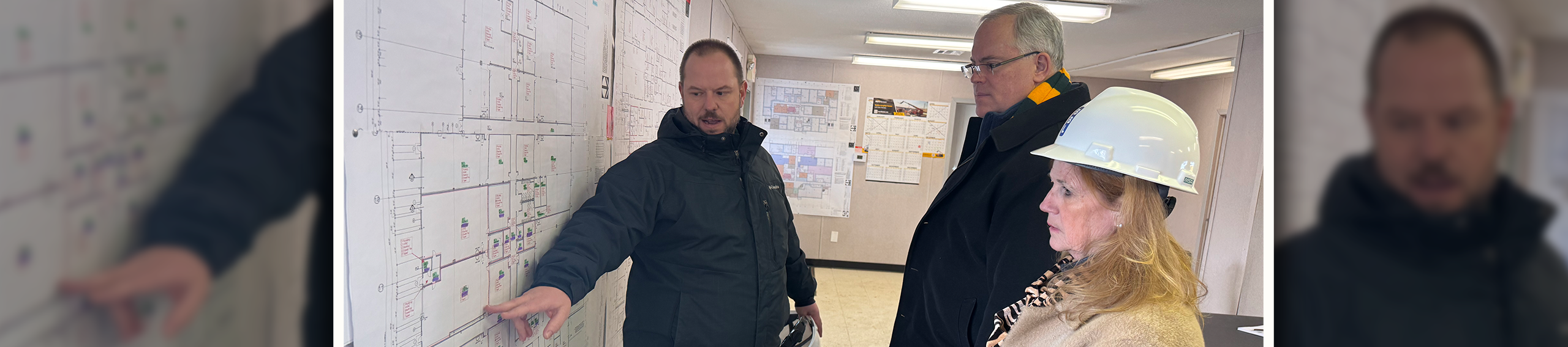 Professionals reviewing building blueprints